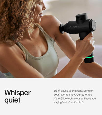Woman using the whisper-quiet Hypervolt 2 on her shoulder